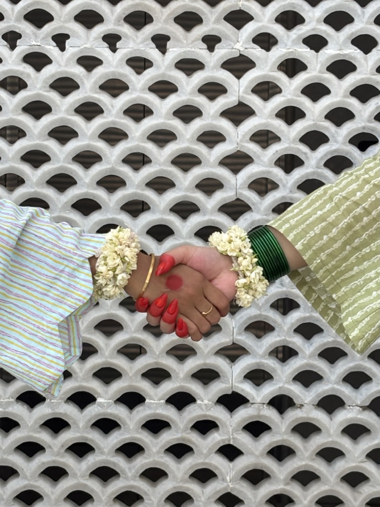 Three women in hand block-printed kurtis — tulip, paisley, and leaf motifs